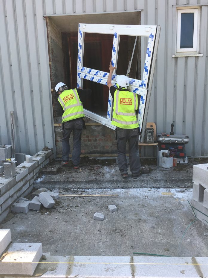 The Nolan uPVC team installing a door at the Swansea NHS Nightingale Hospital